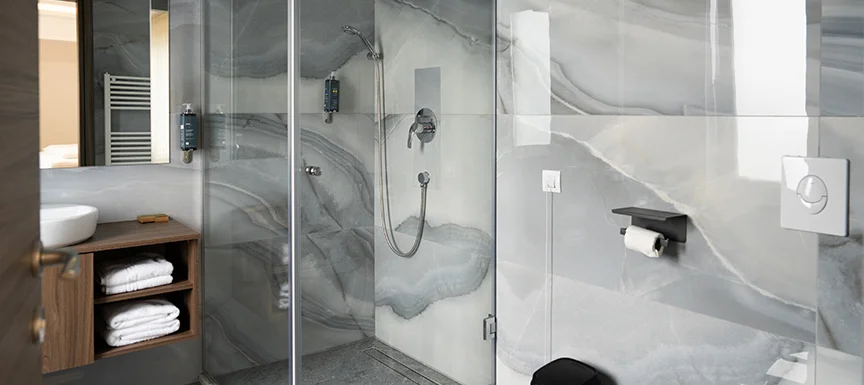 Glass shower enclosures and partitions